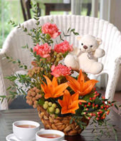 Orange Lilies With Carnations, And Other Flowers In A Basket With White Bear 