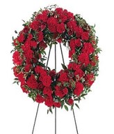 Red Carnations and plump Red Roses,accented with Red Gladiolas.Easel not included.