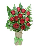 A dozen red roses arrive perfectly arranged