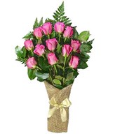 A dozen pink roses arrive perfectly arranged