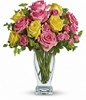 Yellow and light pink roses, pink spray roses and fresh greenery. Approximately 13