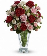 red and pink roses, white and light pink spray roses and greens