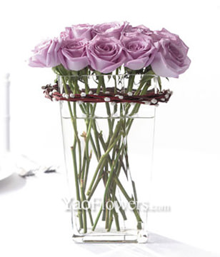 12 purple roses with a glass vase