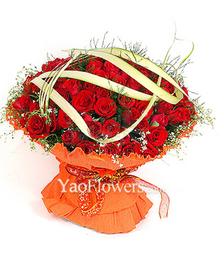 99 red roses with gladiolus and green foliages