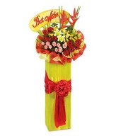 Opening stand arrangement of red gerberas, lilies & pink roses