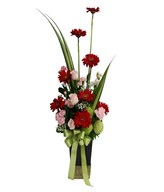 Pink Roses, Pink Carnations, red gerberas, baby Breath and Filler in Ceramic vase
