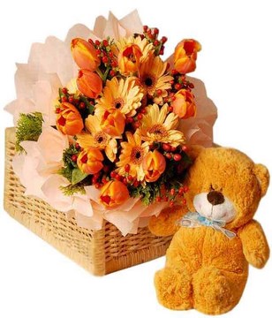 Tulips, gerberas and hypericum with bear