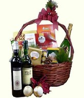 Champagne, 2 bottles of wine with assorted chocolates and titbits in a basket