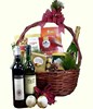 Champagne, 2 bottles of wine with assorted chocolates and titbits in a basket