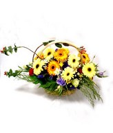 Basket of colorful gerberas, eustomas, carnations, and berries
