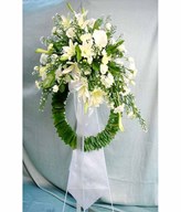Funeral stand with lilies and roses