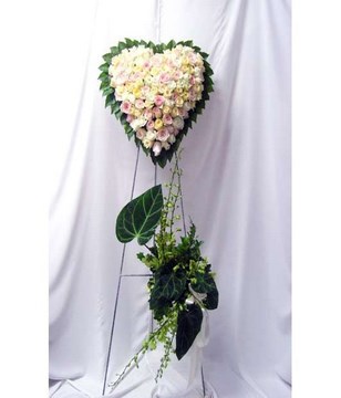 Heart-shaped floral arrangement of pastel roses