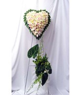 Heart-shaped floral arrangement of pastel roses