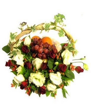 arrangement of red roses with fruits in a basket