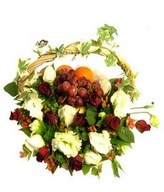 arrangement of red roses with fruits in a basket